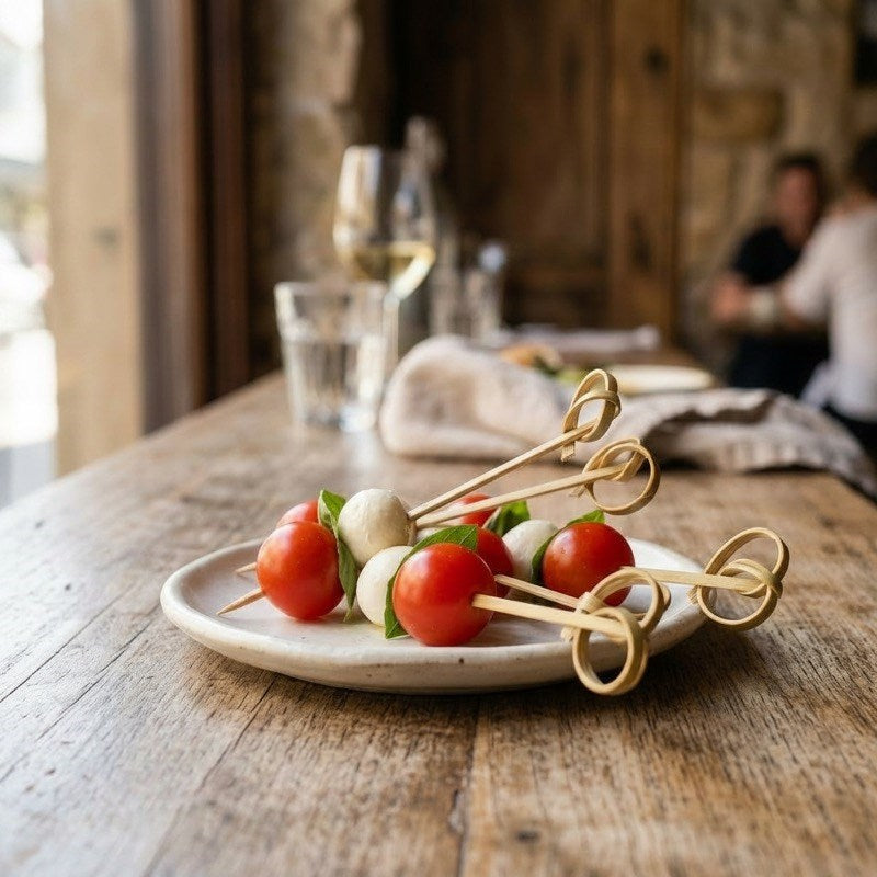 Zeropac bamboo looped caprese skewers with tomato, mozzarella, and basil at formal dining table