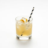 Black striped paper straw in whiskey cocktail with lemon twist