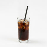 Black paper straw in cola soft drink with ice