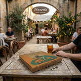 Printed pizza box on table at Italian pizzeria outdoor seating area