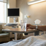 Patient holding water glass with Zeropac flexi straw in hospital