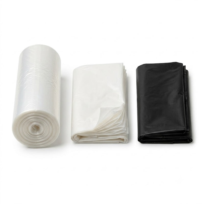 Zeropac wheelie bin liner collection with translucent roll and white and black folded stacks on seamless pure white background