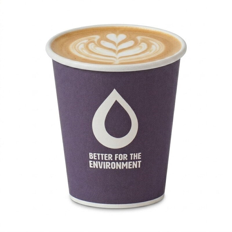 Person holding Zeropac single wall coffee cup with latte at busy cafe counter