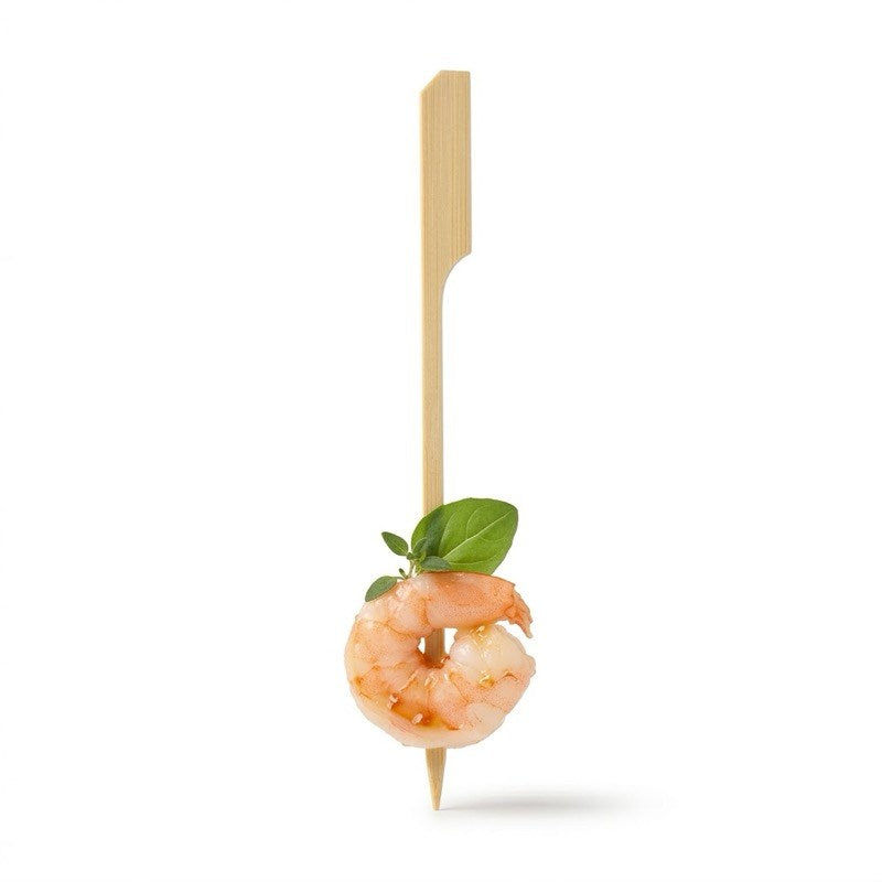 Bamboo boat oar skewer with cooked shrimp and basil garnish