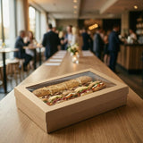 Kraft catering tray with sandwiches displayed at event venue on wooden table