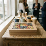 Kraft square catering tray with fresh fruit platter at event venue with coffee