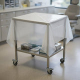 Disposable surface sheet in use on medical cart in clinical setting