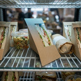 Outdoor farmers market scene with Zeropac sandwich wedges displayed in ice-filled cooler
