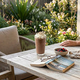 Person enjoying iced chocolate with Zeropac Paper Straw Jumbo Black Stripe in garden