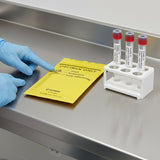 Lab technician with Zeropac Yellow Specimen Bag and test tubes at lab bench